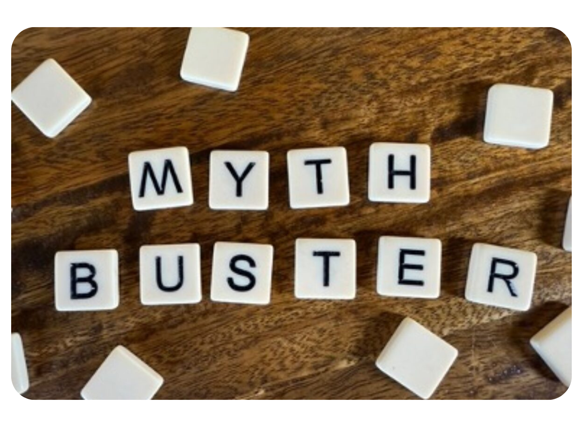 White dominoes laid out on a table to spell the words "Myth Buster"