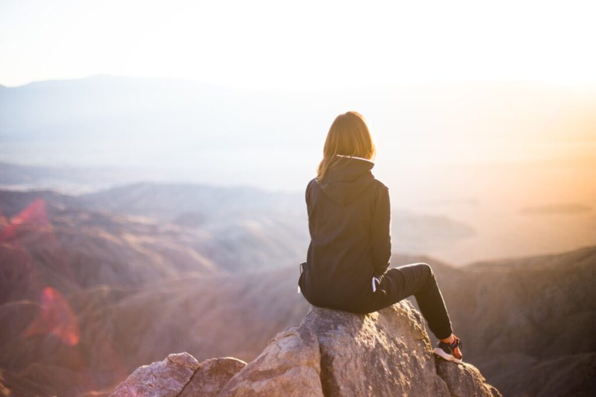 Answering the Call: A Personal Journey Through Our Art Therapy Course woman on the top of a mountain
