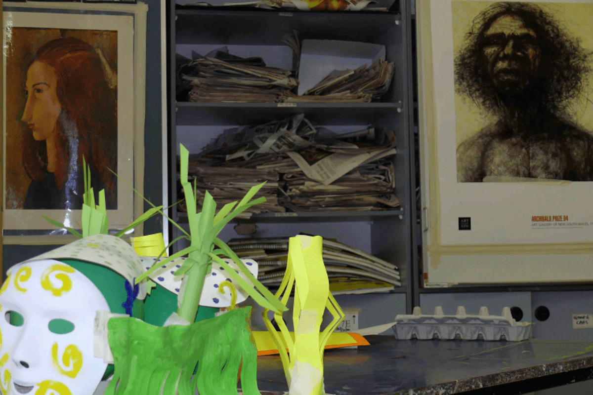 Art Therapy and Trauma - this picture doesn't show trauma directly, but an image of an Aboriginal man, it shows art paper sculptures, magazines and a paint container, bring the topic of trauma to Aboriginal people and art together in a symbolic way.