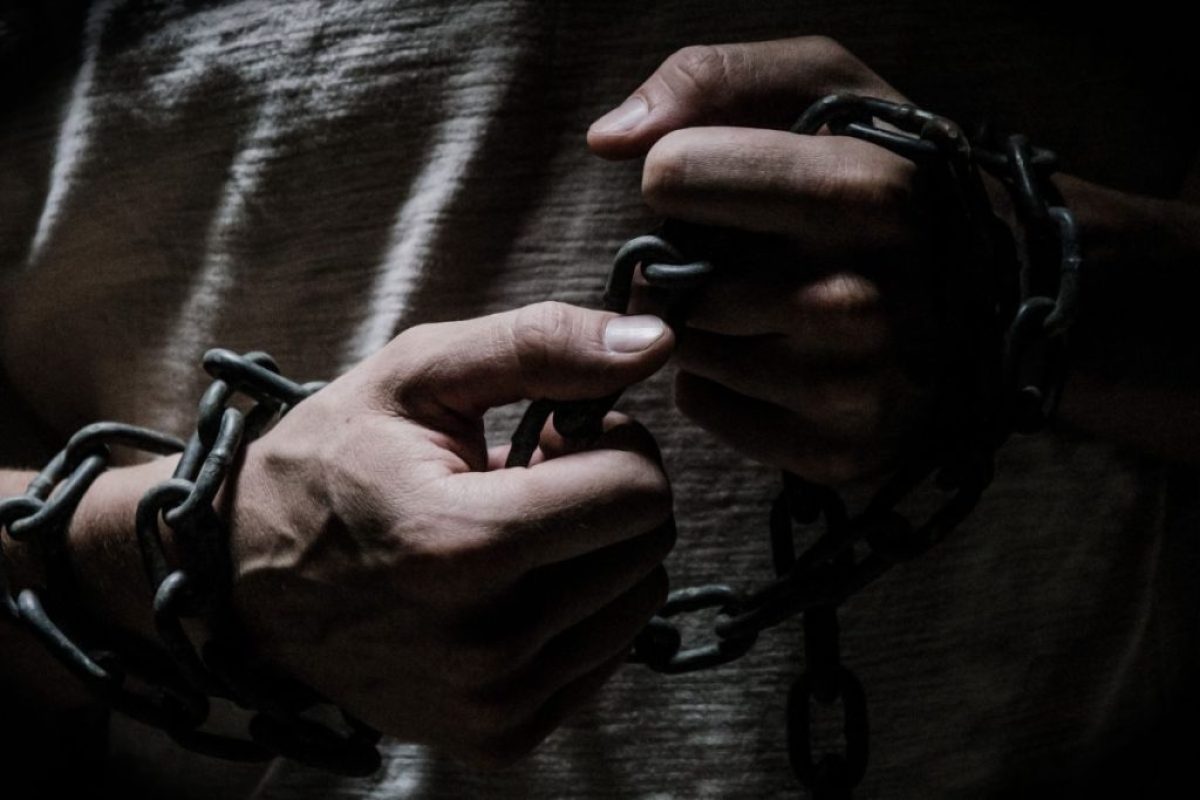 Healing the Invisible Wounds - man holding a chain in his hands symbolising his loss of freedom and his inner wounds.