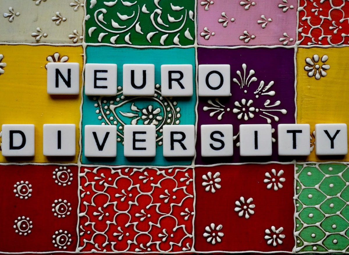 Colourful kitchen tiles with letters on it, building the words Neuro Diversity