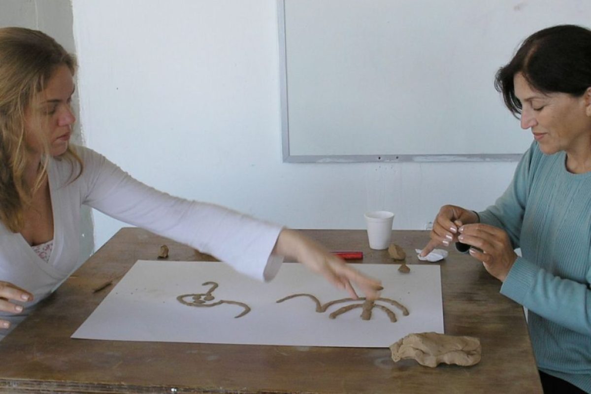 Two women doing art therapy together, and art piece with clay and both from an Israeli and Palestinian background leading to the title of the blog: Peace Between Israelis and Palestinians Through Art Therapy