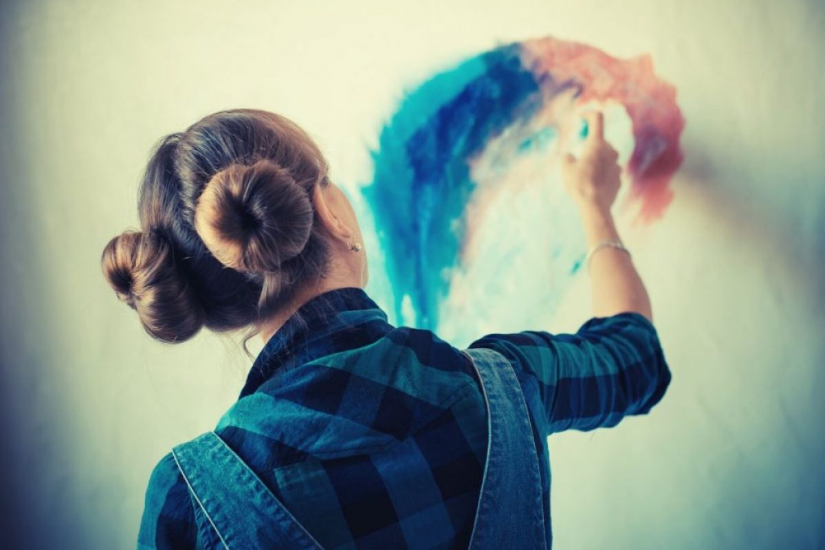 Lady who is painting on the wall and assessing every strock carefully like a review which is the title of this blog: TV Show from the ABC Space 22: An Art Therapist’s Review