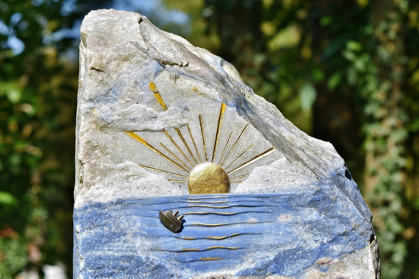Image of a grave stone that has creatively painted and gives hope through the raising sun and leads to title of this blog: The Unspoken Language of Grief: How Art Therapy Can Heal from Personal Loss 