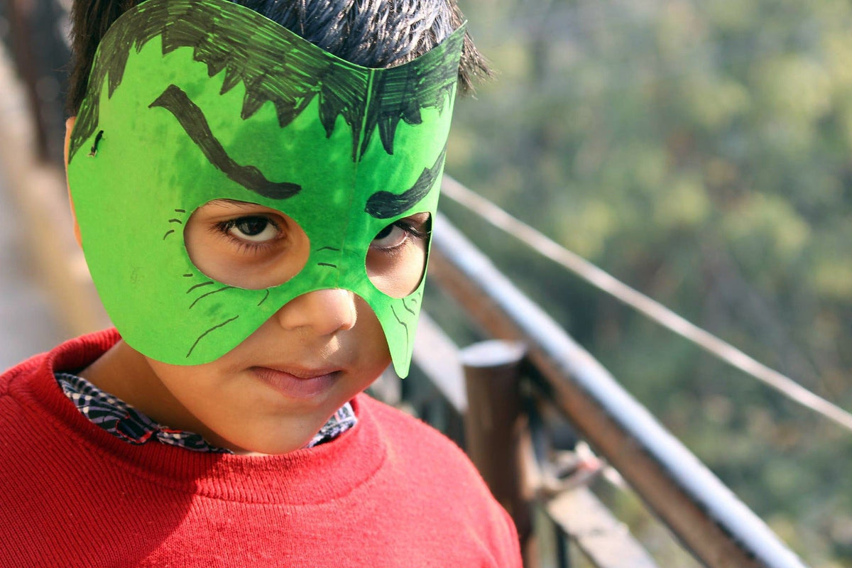 Young boy wearing a Hulk face mask