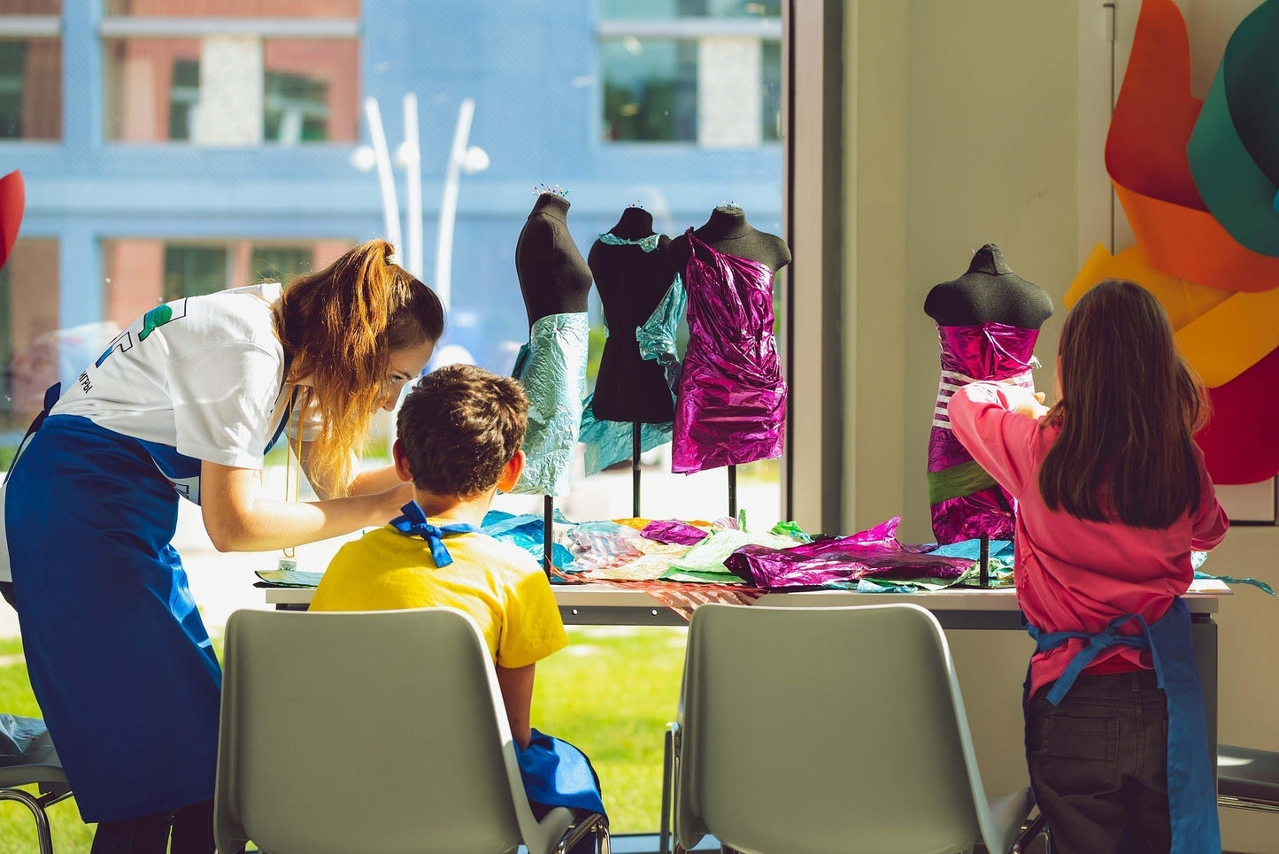 Art Therapy Informed Visual Arts Teacher - Children designing clothes for fashion models with teacher